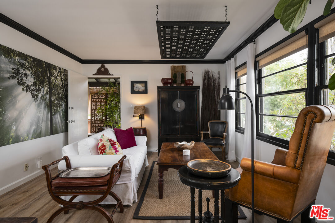 a living room with furniture and a floor to ceiling window