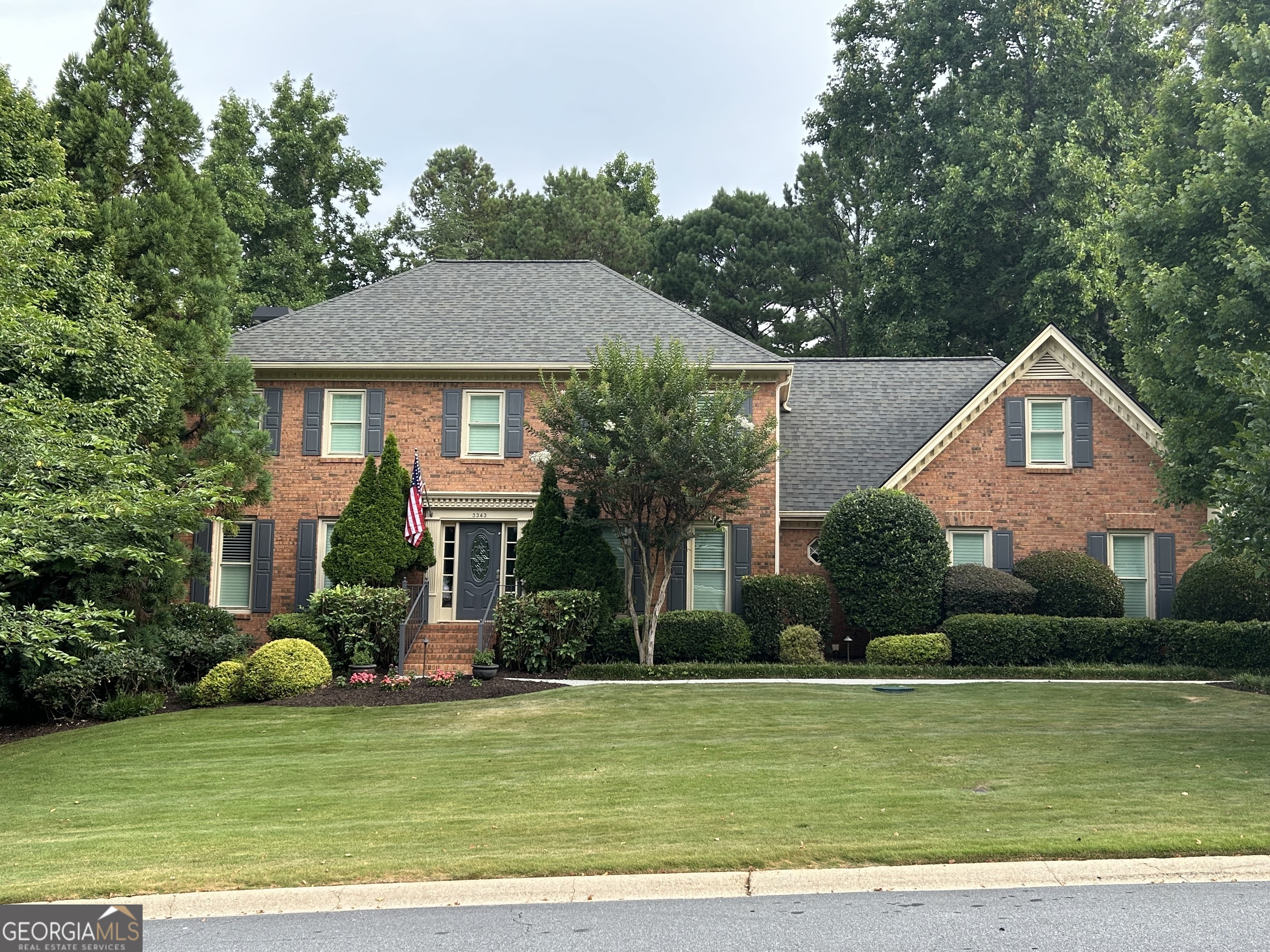 a front view of a house with a garden