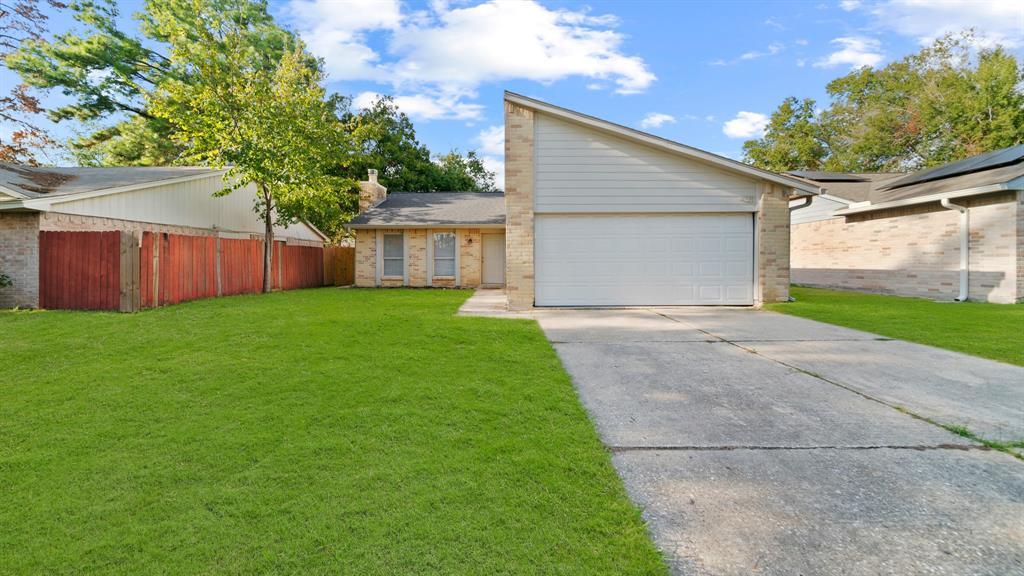 a view of a house with a yard and garage