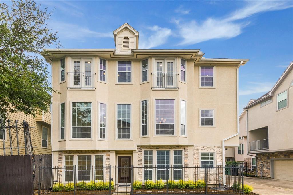 a front view of a residential apartment building with a yard