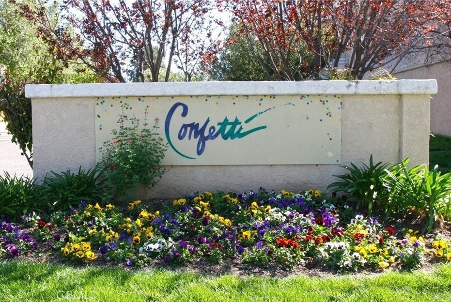 a view of sign board with flower in front of it