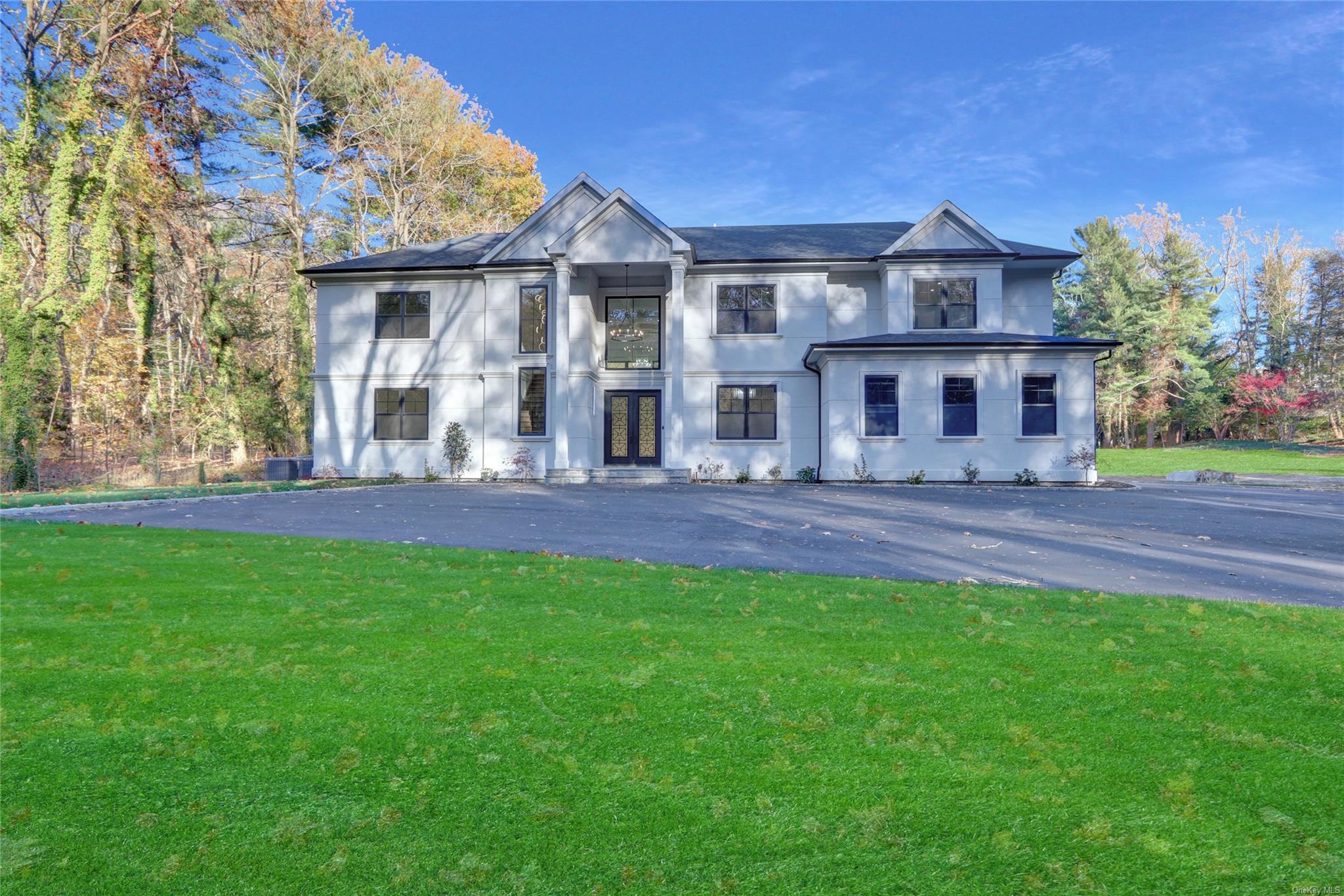 View of front facade featuring a front yard and french doors