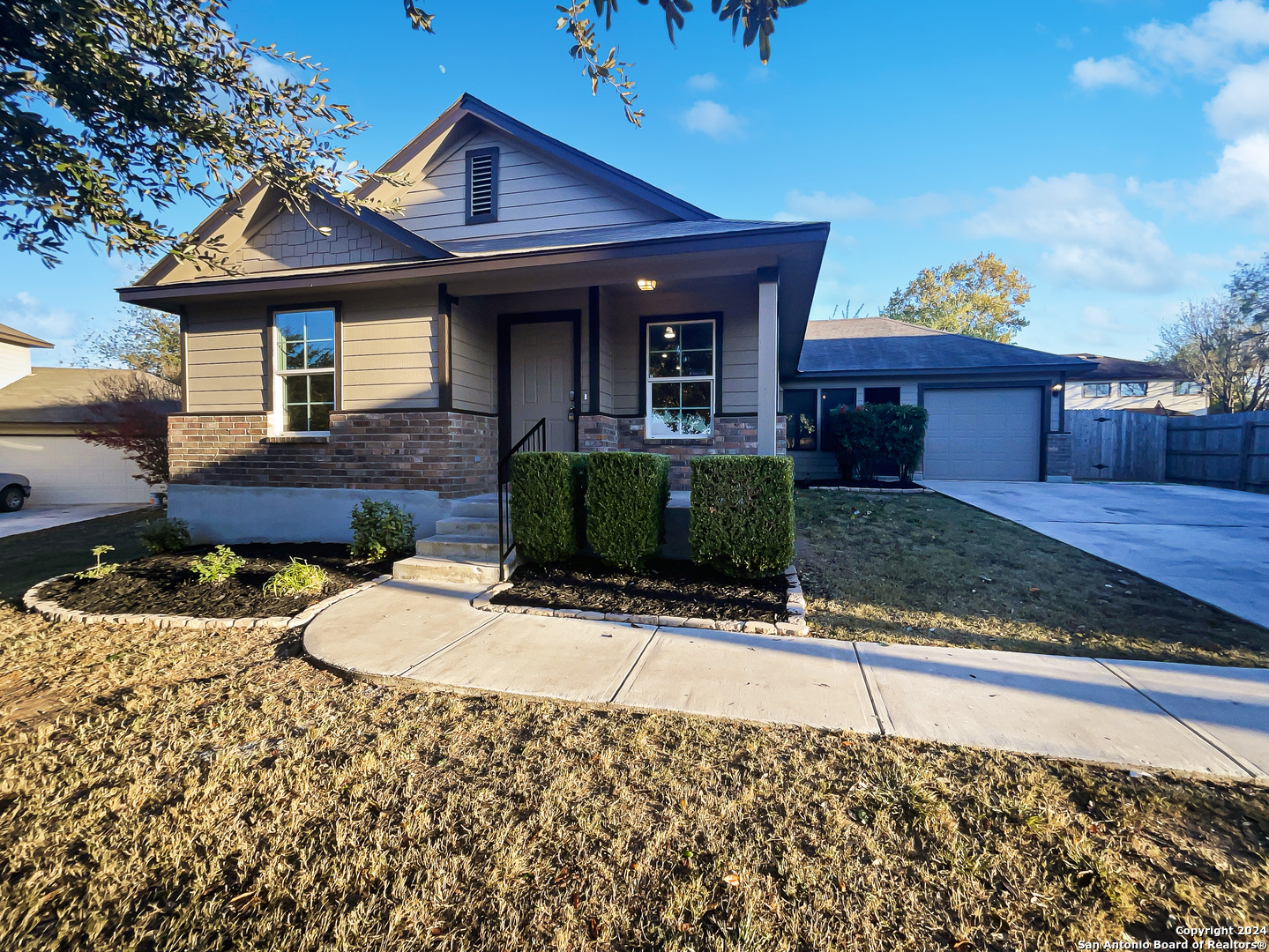 a front view of a house with garden