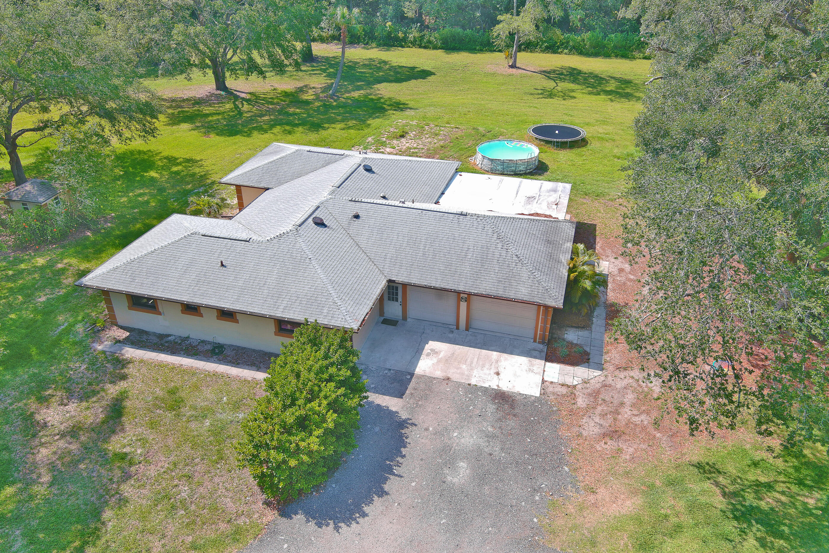 an aerial view of a house with big yard