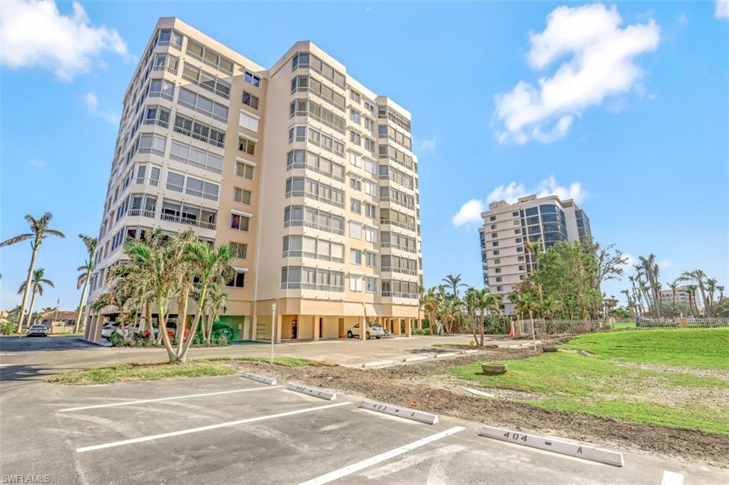 a view of a tall building next to a big yard