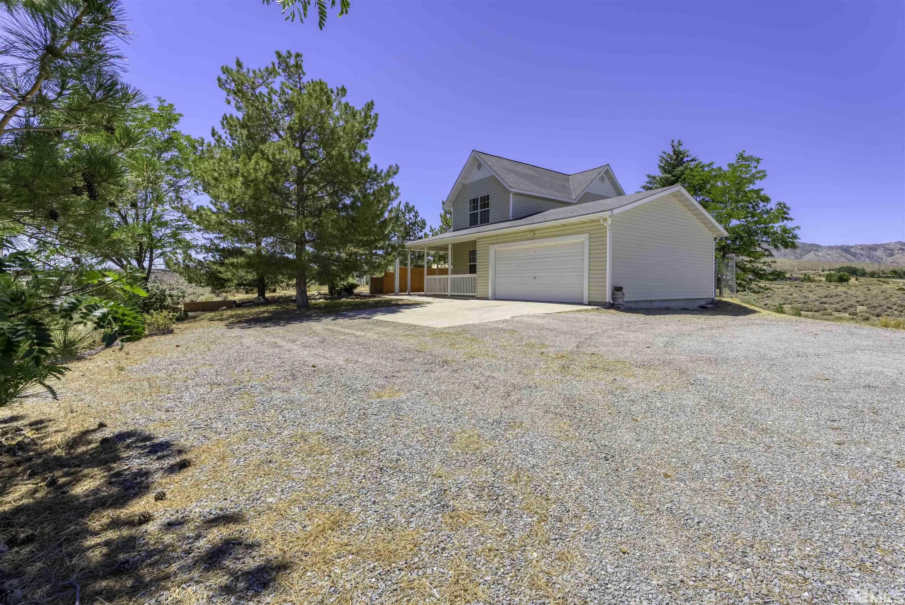 a view of a house with a yard and garage