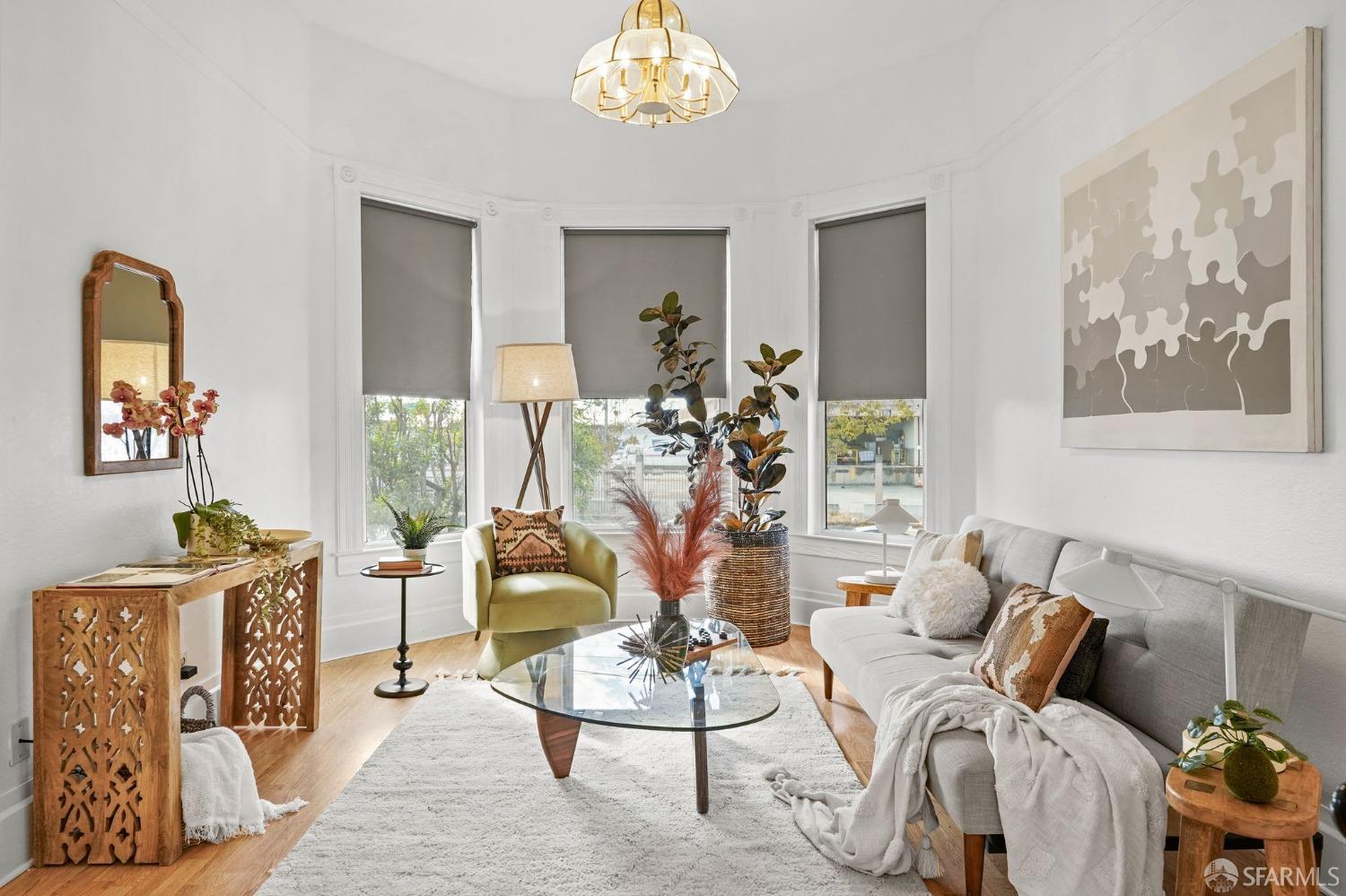 a living room with furniture a chandelier and a window