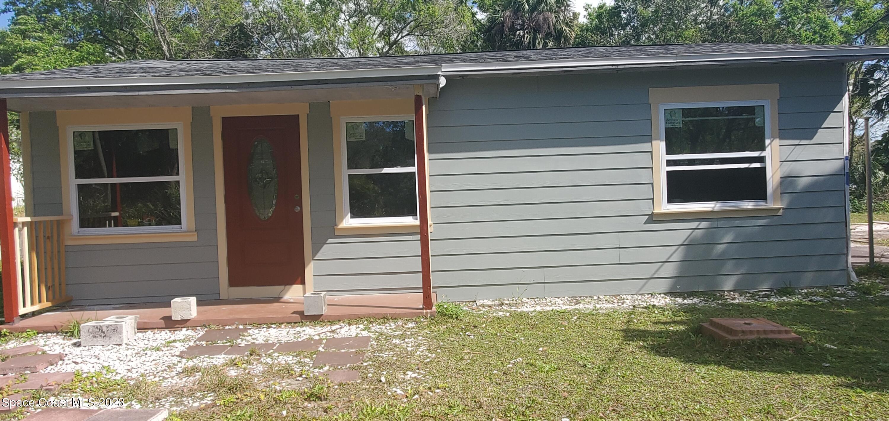 a side view of a house with a yard