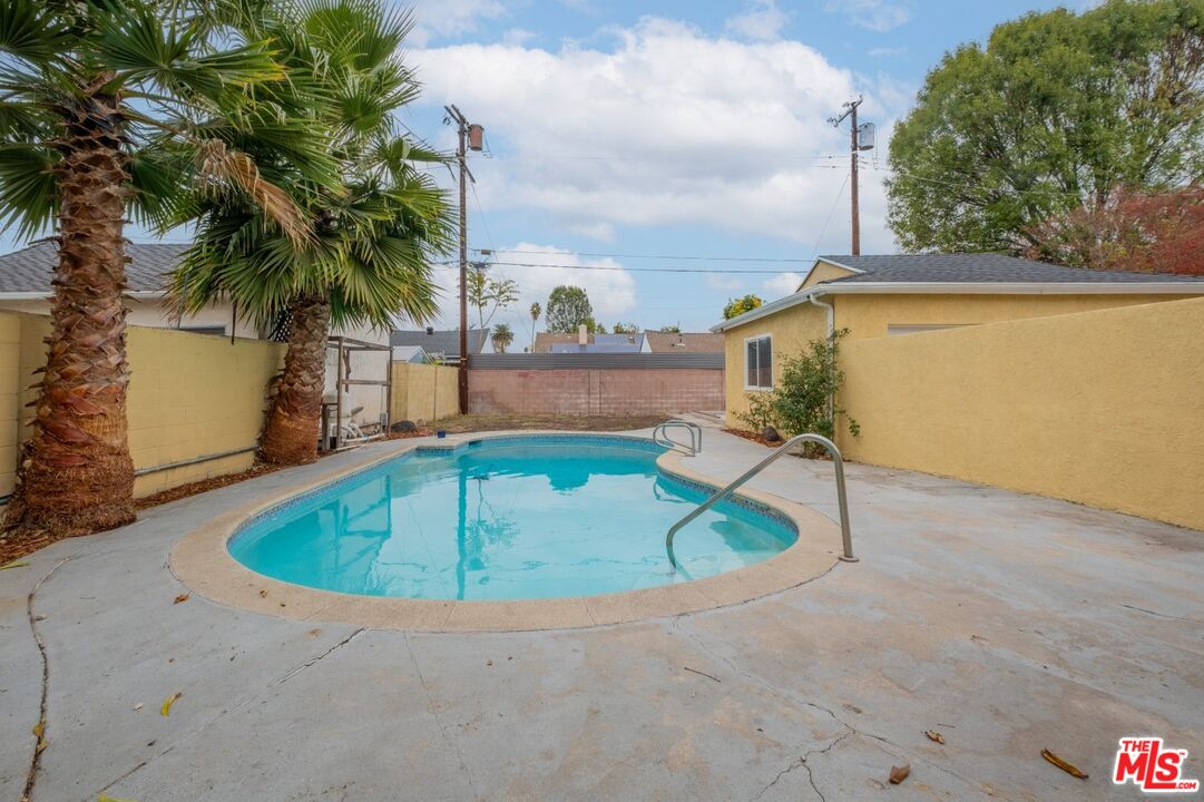 an outdoor space with pool and furniture