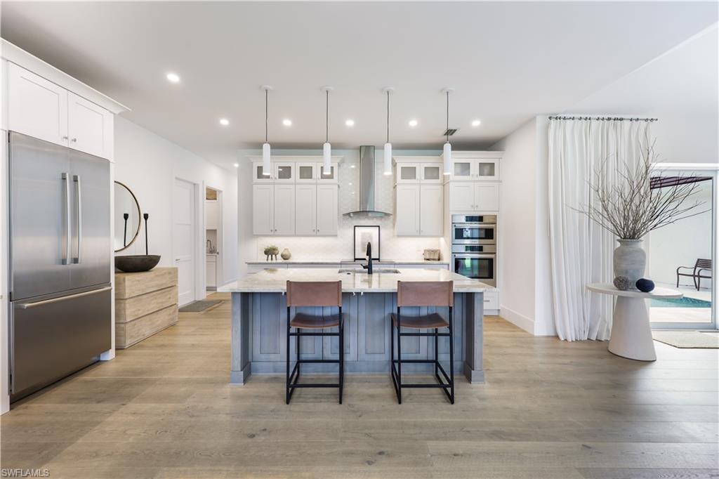 a large kitchen with a table and chairs