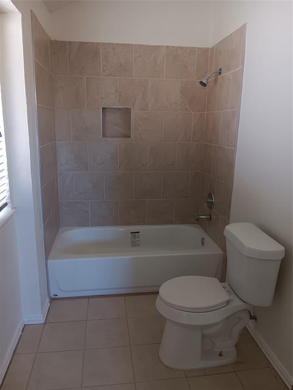 a bathroom with a toilet and a bath tub