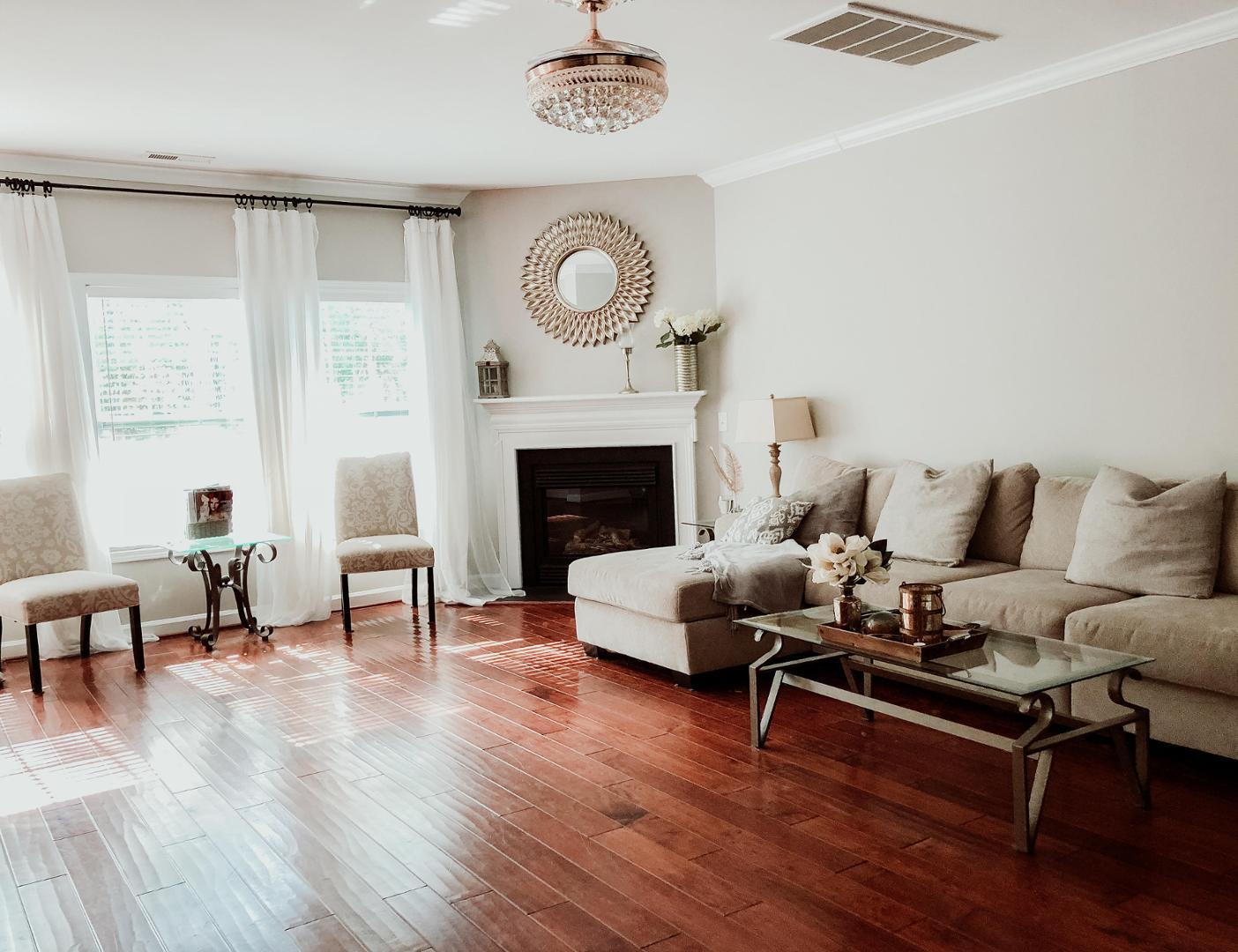 a living room with furniture and a fireplace