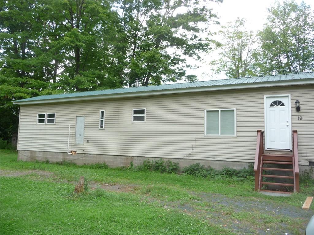 Back of house with a lawn