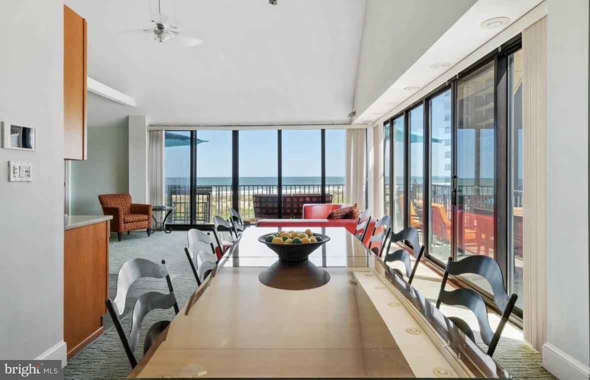 a living room with furniture and floor to ceiling window