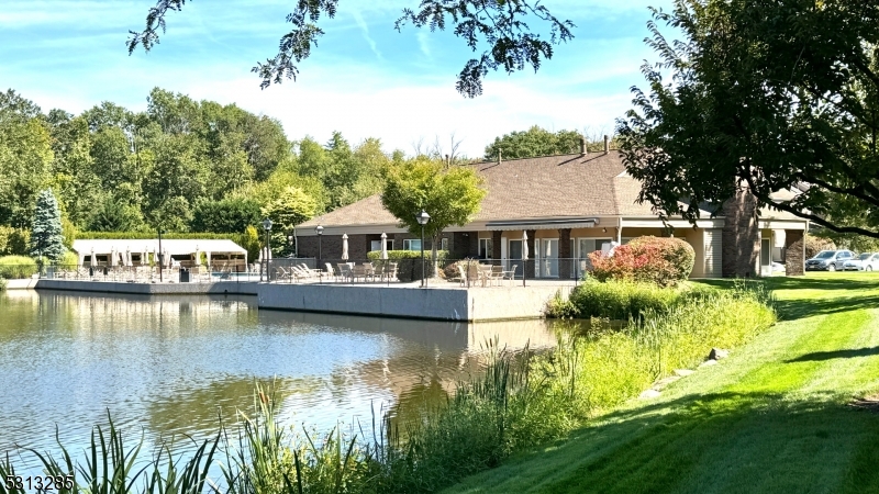 a view of a house with swimming pool and sitting area