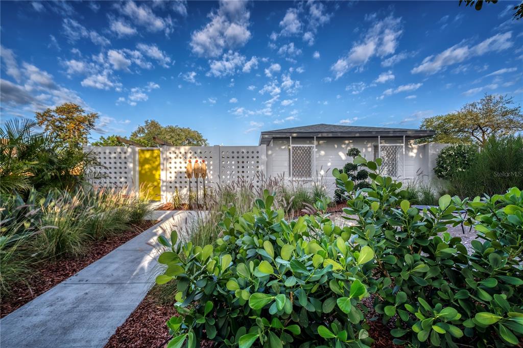 a backyard of a house with lots of green space and garden