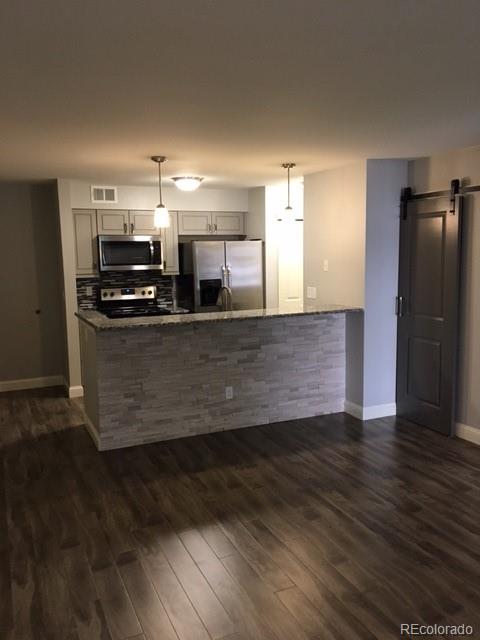 a view of a kitchen with wooden floor