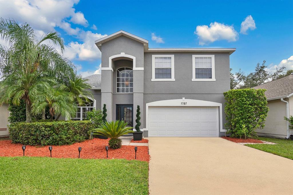 a front view of a house with a yard and garage