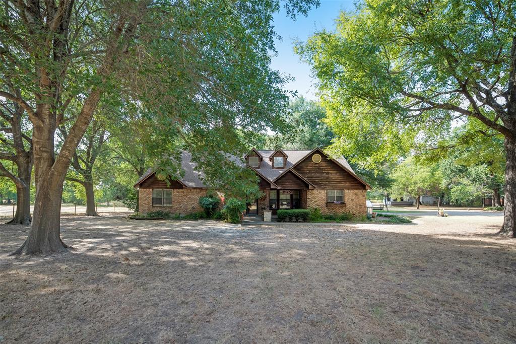 a view of a house with a tree in front of it