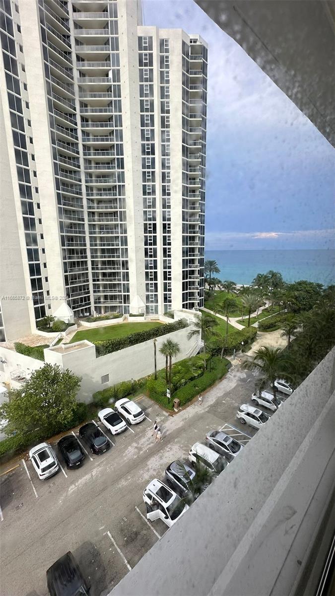 a view of a street with tall buildings