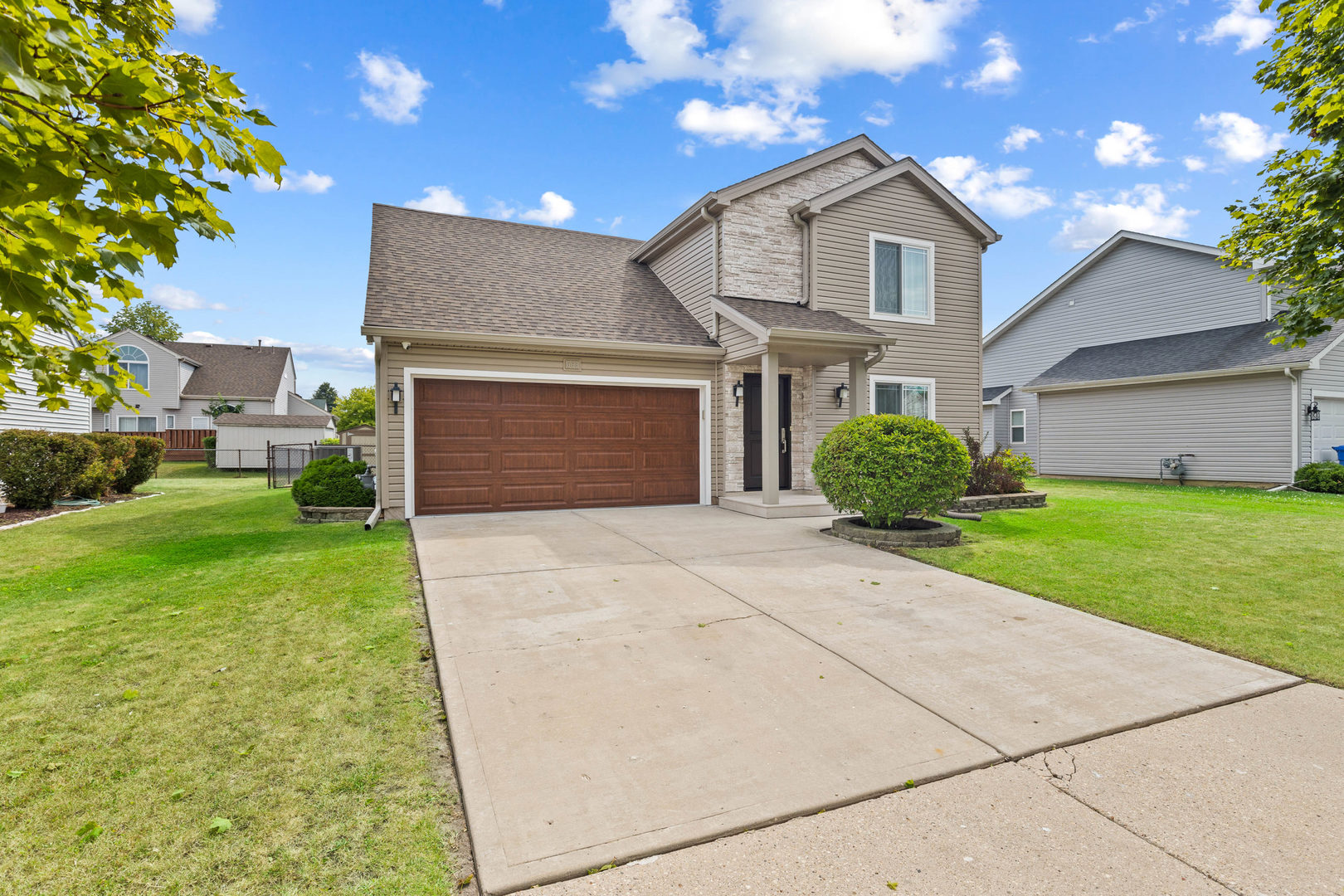 a front view of a house with a yard and garage