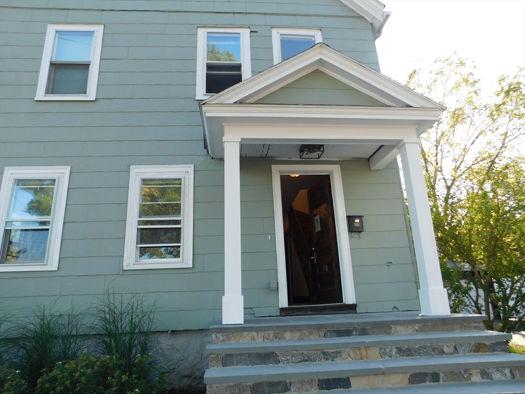 a front view of a house with grey walls