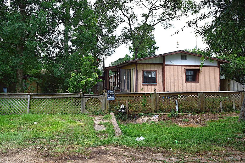 a view of a wooden deck with a yard