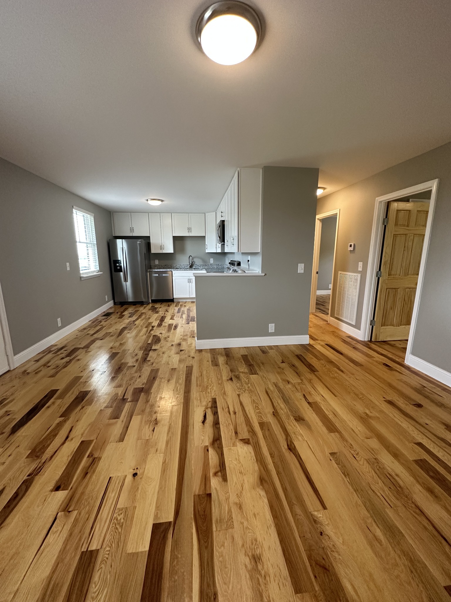 a view of a bedroom with wooden floor and bedroom