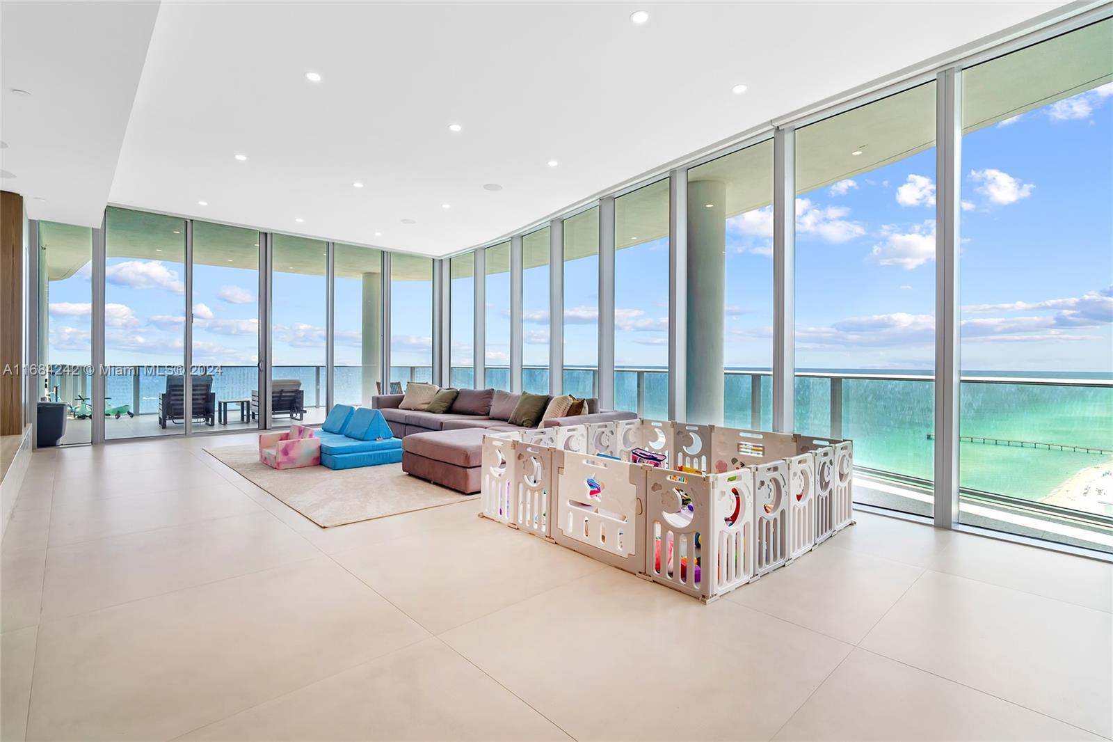 a spacious bedroom with large window and a balcony