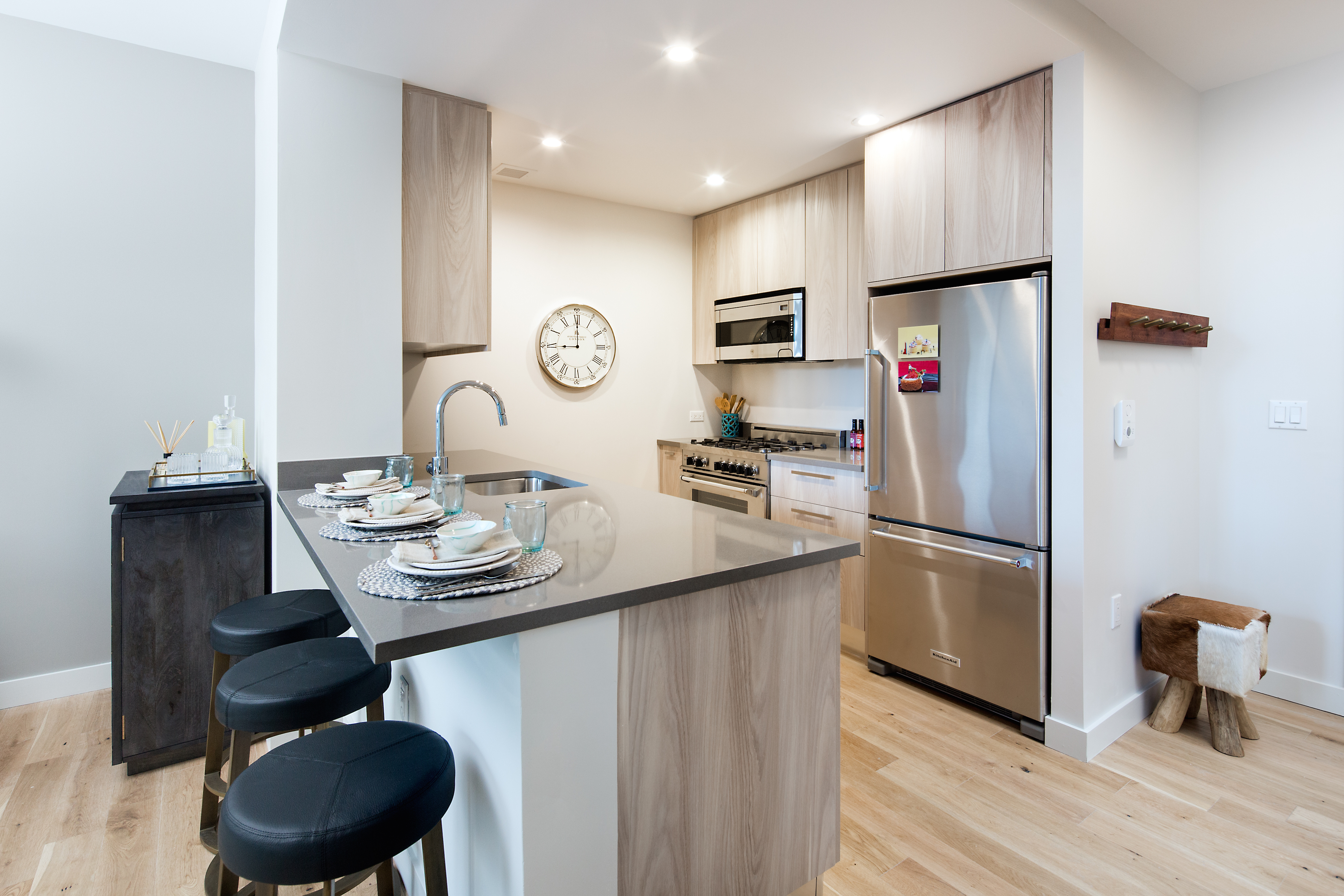 a kitchen with stainless steel appliances granite countertop a sink a stove a refrigerator and cabinets