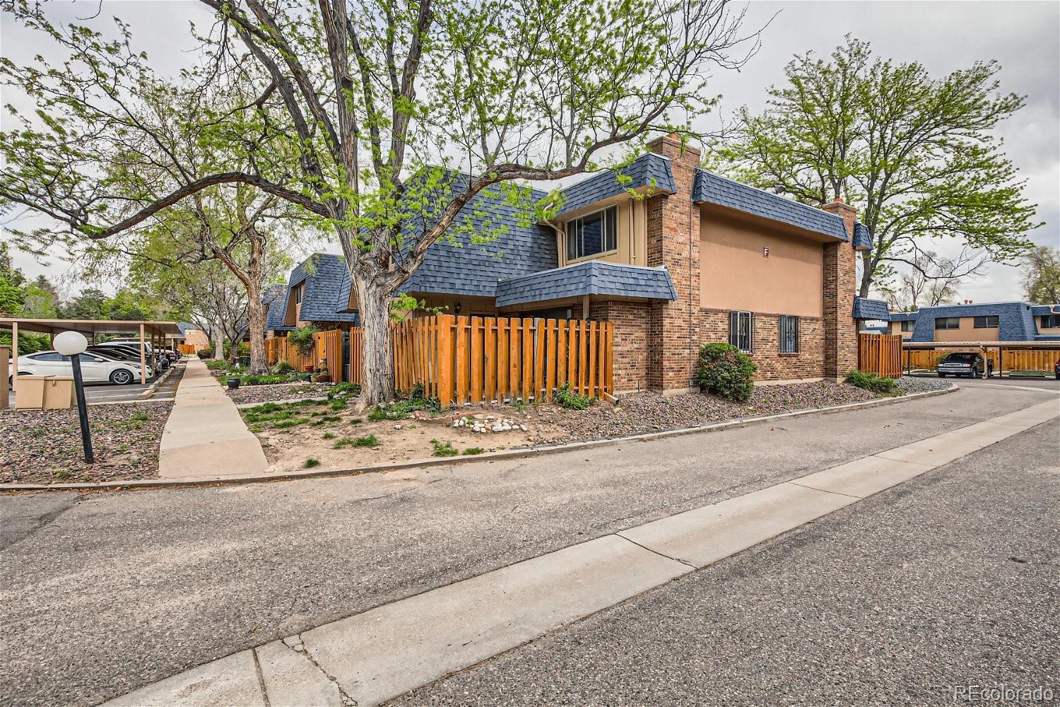 a view of a house with a street next to a road