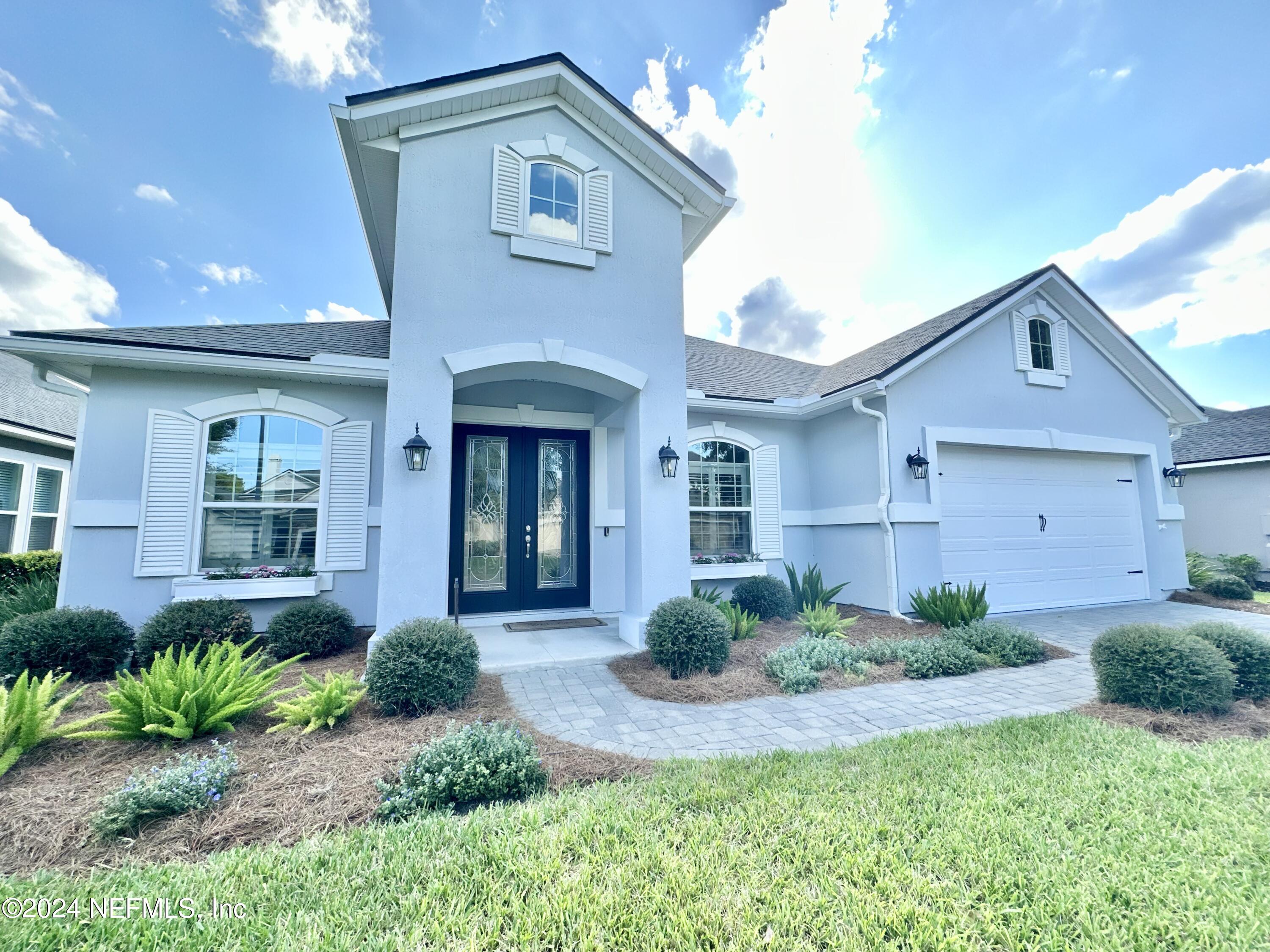 a front view of a house with a yard