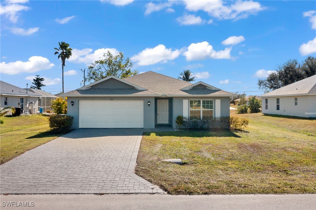 a front view of a house with garden