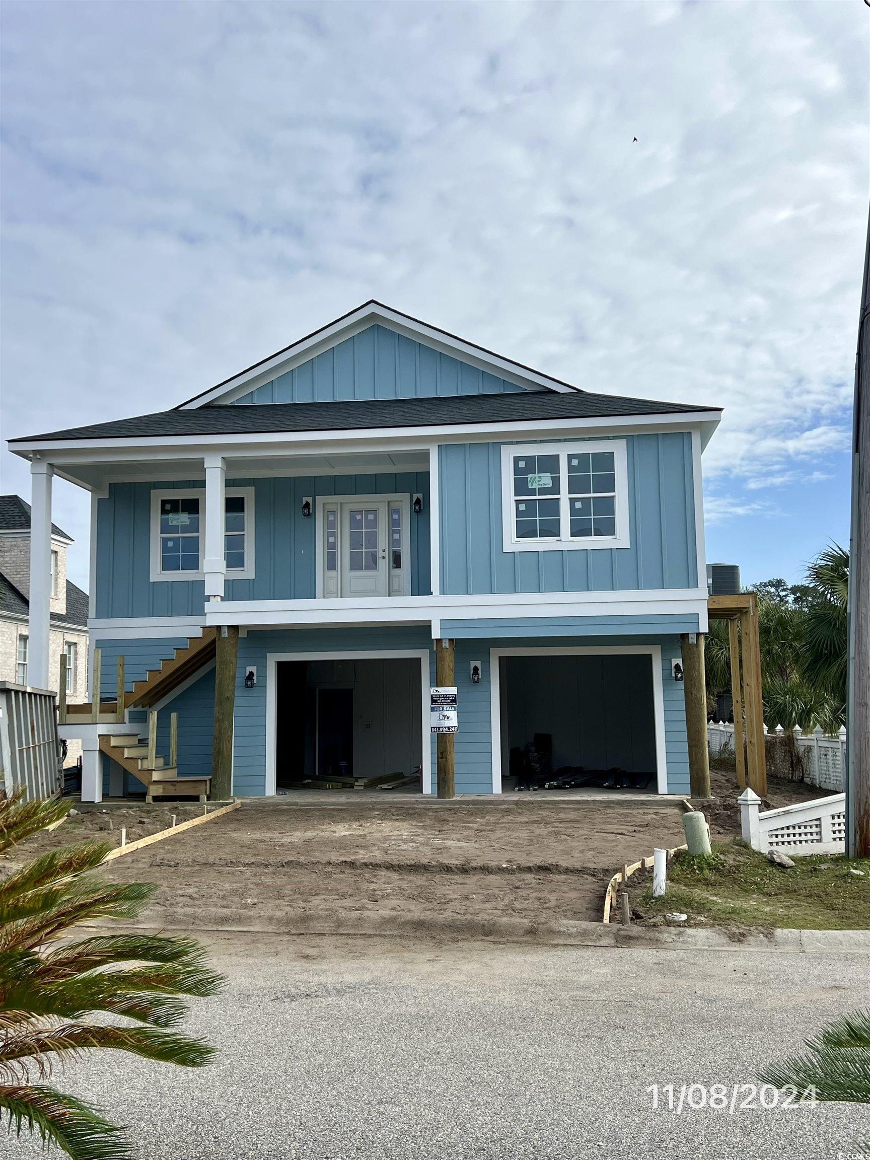 View of front of house featuring a garage and cove