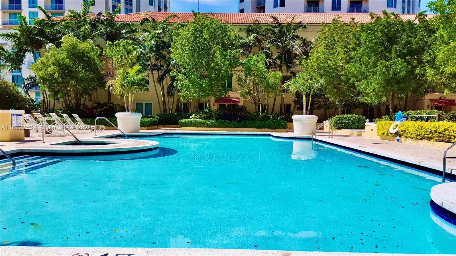 a view of a swimming pool with lounge chairs