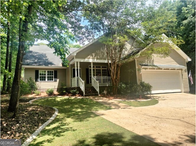 a view of a house with backyard porch and sitting area