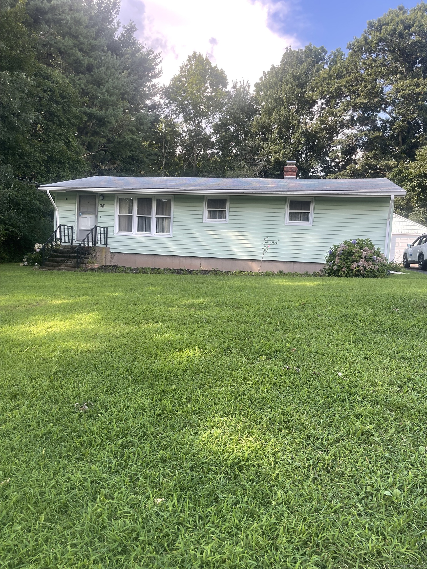 a front view of a house with a garden