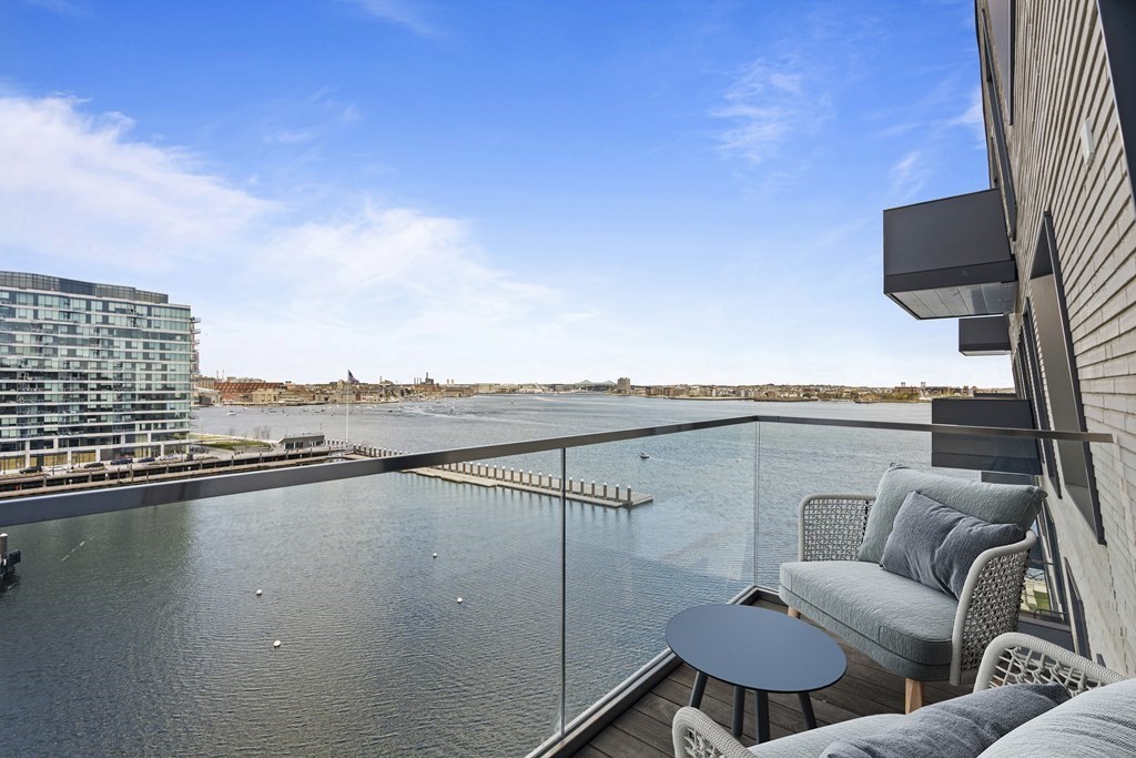 a view of roof deck with seating space and wooden floor