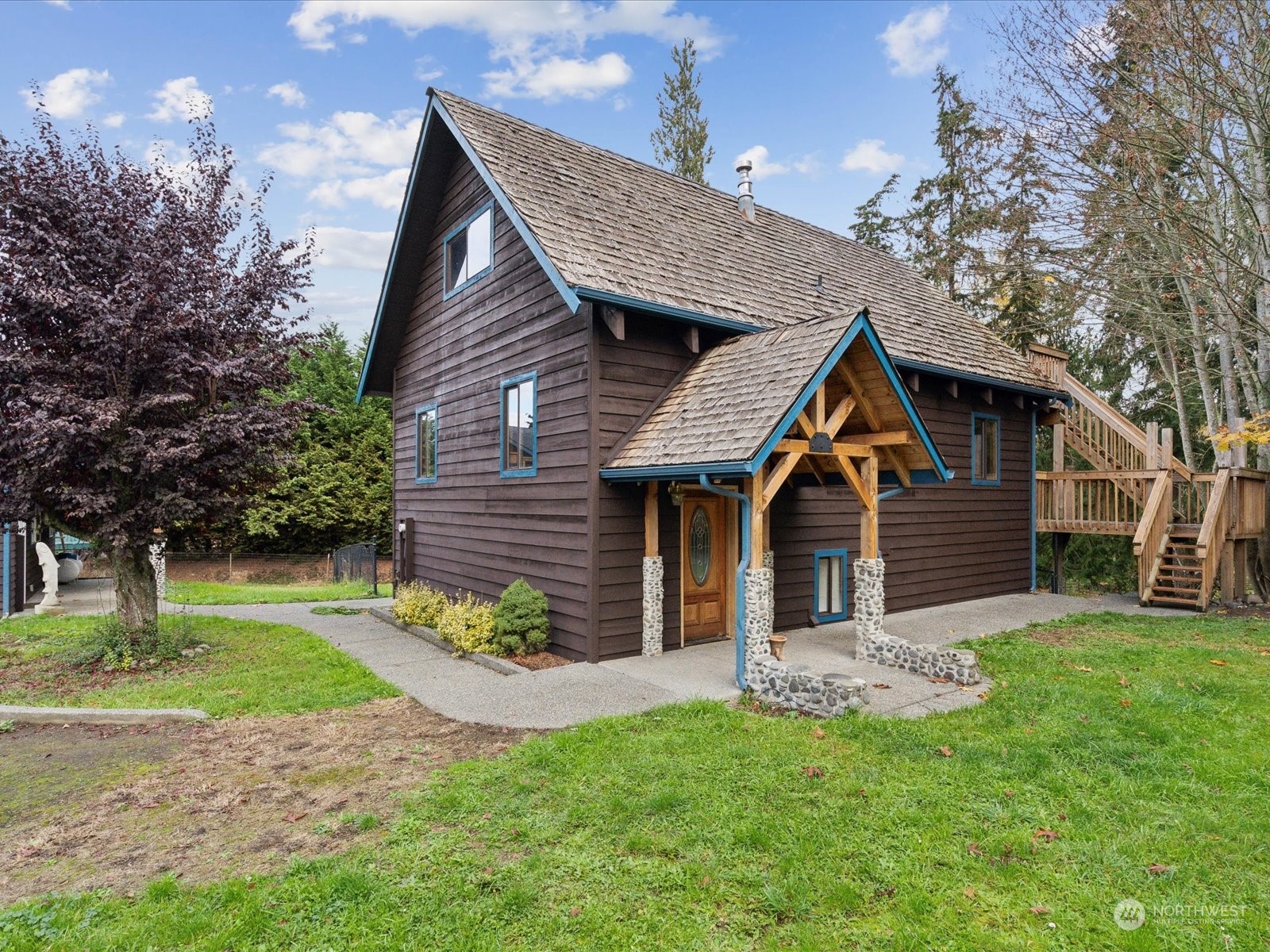 a front view of a house with a garden