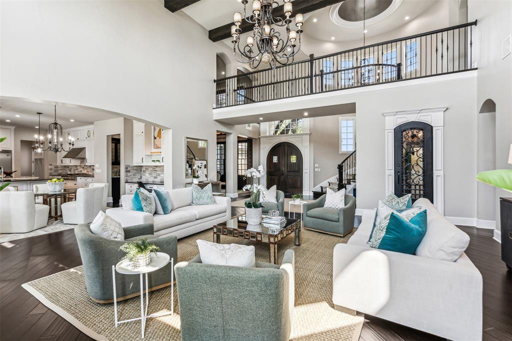 a living room with furniture a chandelier and a fireplace