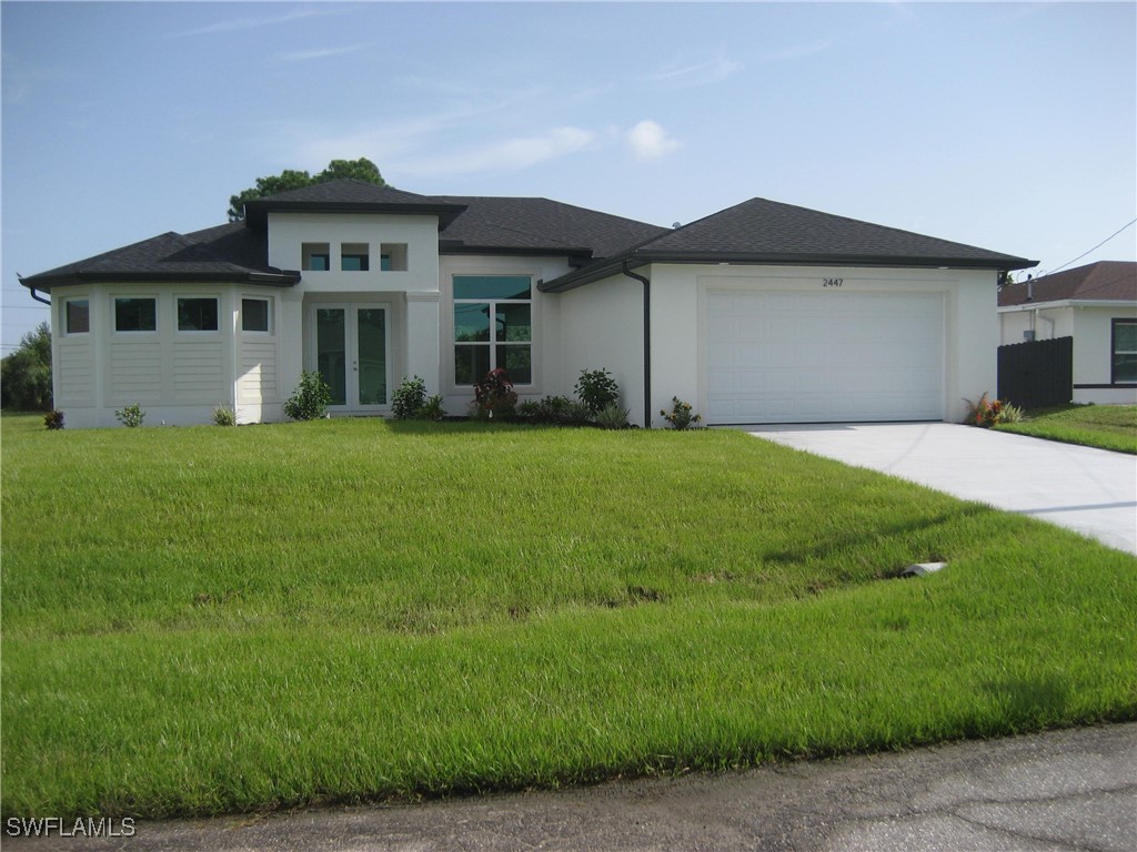 a front view of a house with a garden