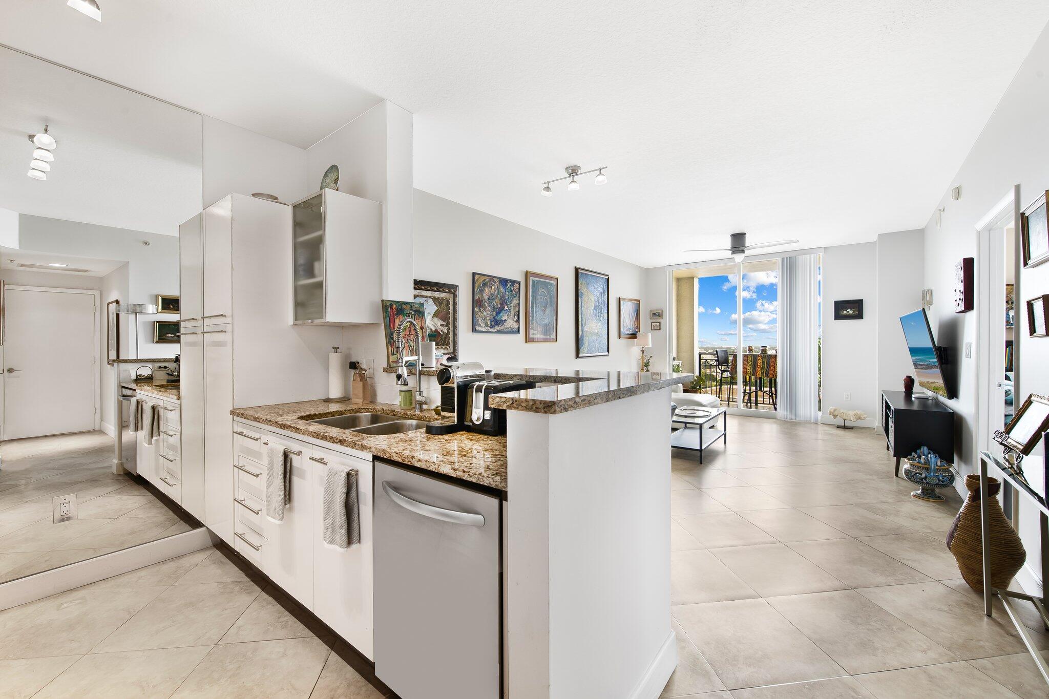 a open kitchen with sink and cabinets