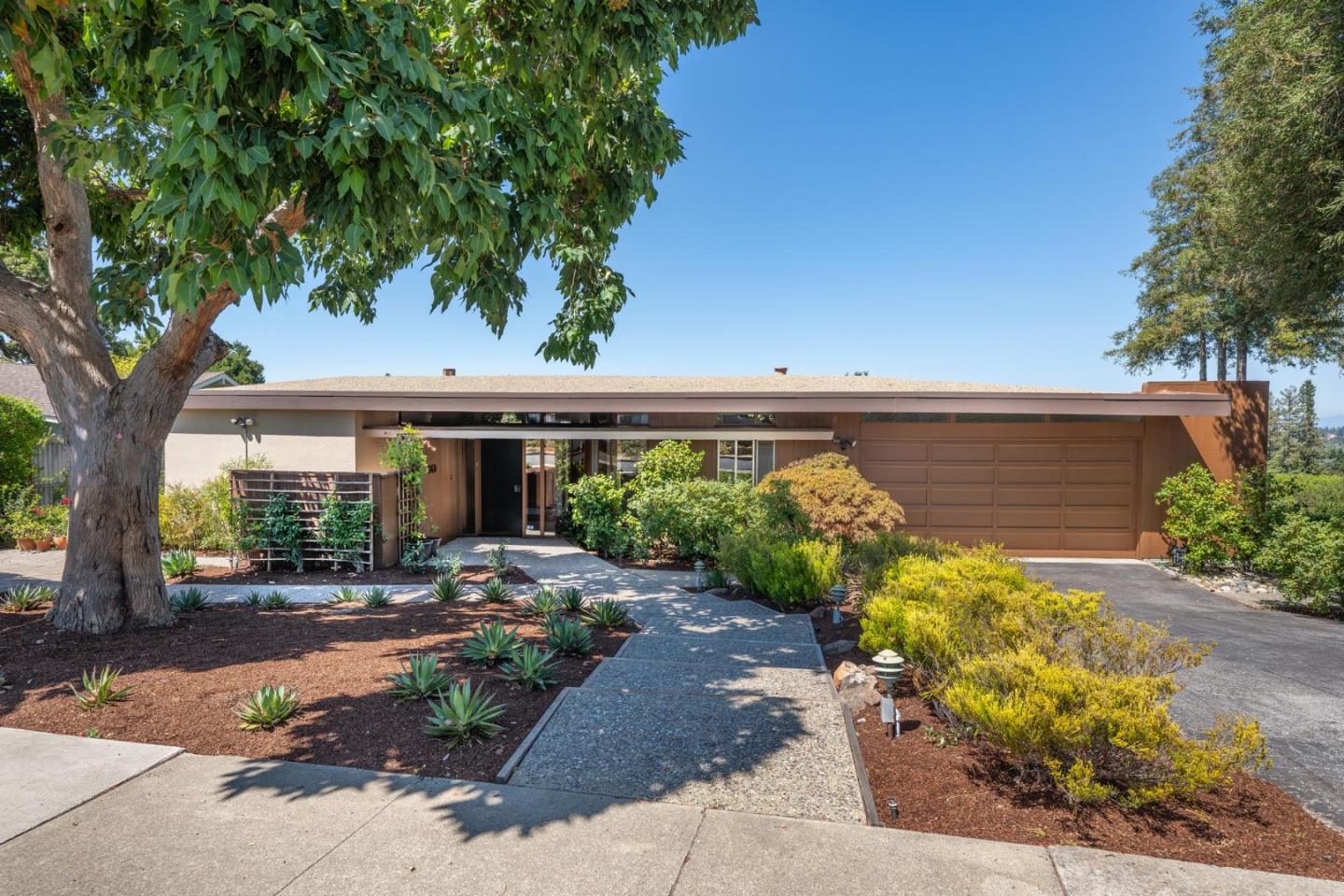 a front view of a house with garden