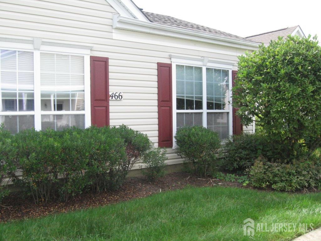 a view of a house with a yard and plants