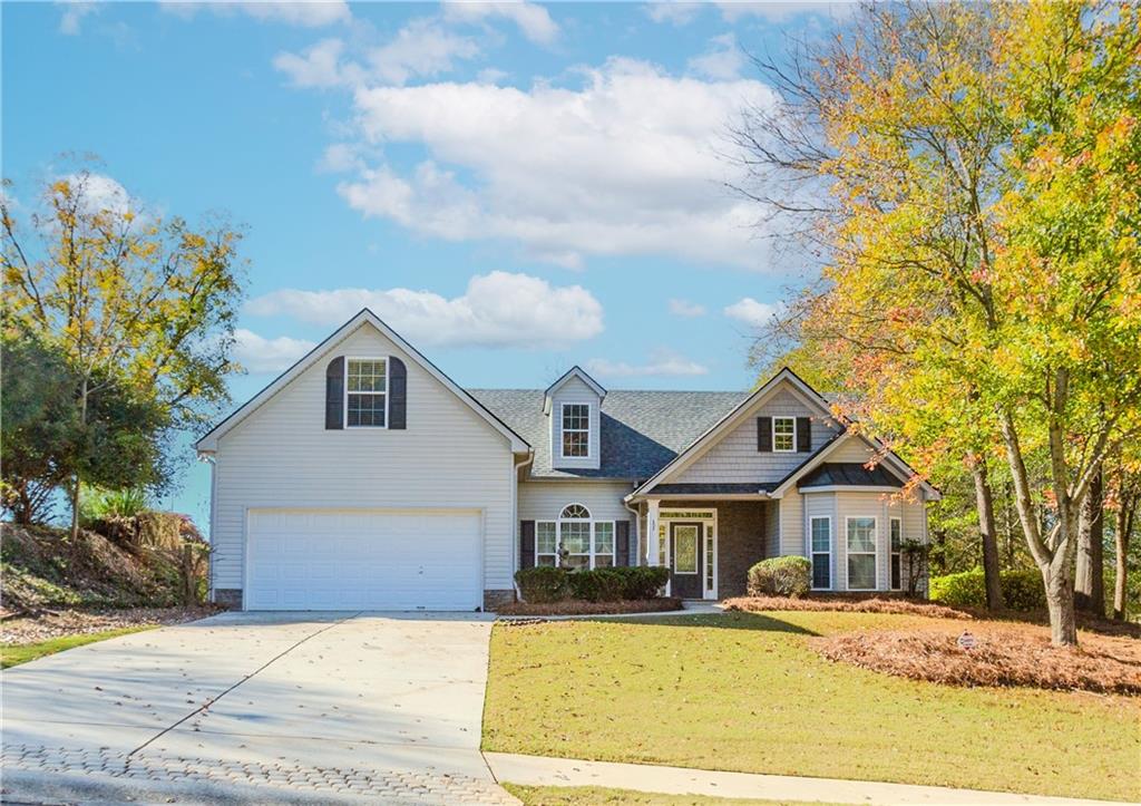 a front view of a house with a yard