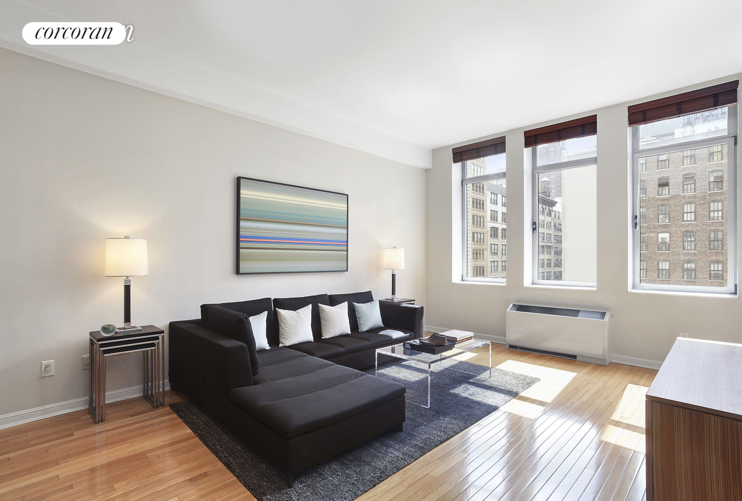 a living room with furniture and a floor to ceiling window