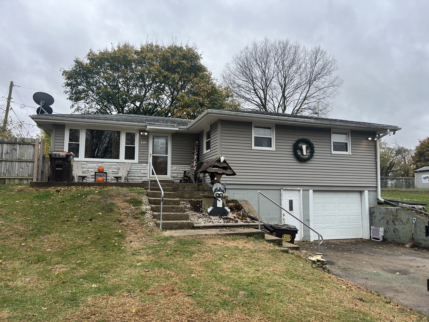 a view of a house with a patio and a yard