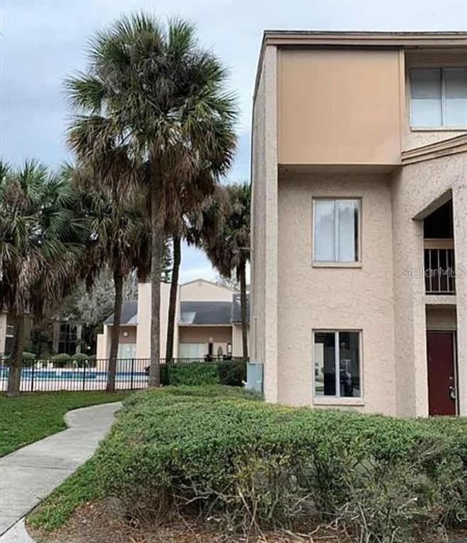 a house with palm tree in front of it