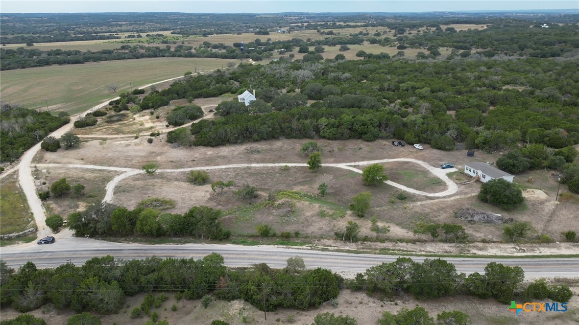 an aerial view of residential houses with outdoor space and lake view