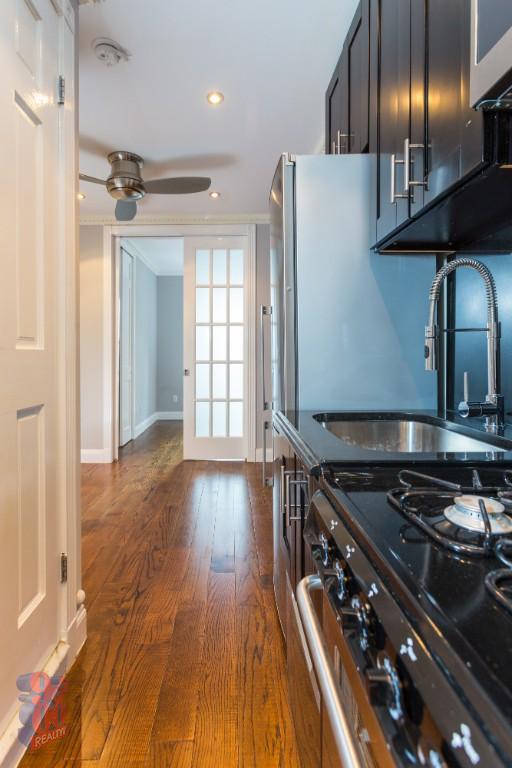 a kitchen with wooden floors and appliances